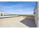 Expansive rooftop deck with light stone pavers, scenic views and an outdoor living space at 1257 Rhett Dr, Erie, CO 80026