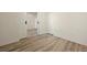 Bedroom with light wood floors and a doorway to the next room at 13640 E Iliff Pl, Aurora, CO 80014