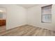 Bright bedroom features wood-look floors and a window with wood blinds, providing natural light at 13640 E Iliff Pl, Aurora, CO 80014