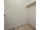 Walk-in closet provides storage with wood-look flooring at 13640 E Iliff Pl, Aurora, CO 80014