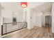 Bright hallway with wood floors and stairway to upper level at 13640 E Iliff Pl, Aurora, CO 80014