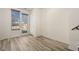 Bright living room with light wood floors and a door to the outdoor space at 13640 E Iliff Pl, Aurora, CO 80014