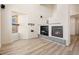 Bright living room with hardwood floors, large window and fireplace at 13640 E Iliff Pl, Aurora, CO 80014