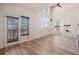 Bright living room with wood-look floors, natural light, and access to outdoor space at 13640 E Iliff Pl, Aurora, CO 80014