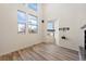 Bright living room with hardwood floors, modern fixtures and large windows at 13640 E Iliff Pl, Aurora, CO 80014