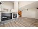 Bright living room with hardwood floors and a fireplace open to the kitchen at 13640 E Iliff Pl, Aurora, CO 80014