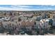 Aerial shot of colorful townhomes in a neighborhood with lots of trees and blue sky at 13640 E Iliff Pl, Aurora, CO 80014