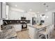 Modern kitchen with a center island with seating, stainless steel appliances, and ample cabinet space at 1043 S Fultondale Ct, Aurora, CO 80018