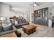 Spacious living room features a cozy seating area, custom built-in shelving and cabinets, and lots of light at 1043 S Fultondale Ct, Aurora, CO 80018