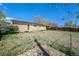 Spacious backyard with partial grass, exterior brick, small patio, and wooden fence at 11674 Claude Ct, Northglenn, CO 80233