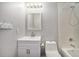 Bathroom with new vanity, toilet, and shower with white tile at 11674 Claude Ct, Northglenn, CO 80233