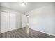 Bright bedroom featuring hardwood floors and double door closet at 11674 Claude Ct, Northglenn, CO 80233