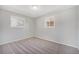 Bedroom with two bright windows and neutral carpeting at 11674 Claude Ct, Northglenn, CO 80233