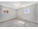 Bedroom with two bright windows and neutral carpeting at 11674 Claude Ct, Northglenn, CO 80233