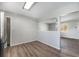 Open dining space featuring wood-look flooring and sightlines to the living area at 11674 Claude Ct, Northglenn, CO 80233