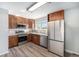 Modern kitchen featuring granite countertops, stainless steel appliances, and wood cabinets at 11674 Claude Ct, Northglenn, CO 80233