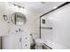 Clean bathroom featuring a shower and a vanity with modern fixtures and a round mirror at 15946 Little Bluestem Rd, Monument, CO 80132