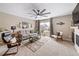 Cozy living room features a large window, stylish decor, and a ceiling fan at 15946 Little Bluestem Rd, Monument, CO 80132