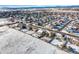 Aerial view showcases the home nestled in a community with snowy surroundings at 1180 Crenshaw St, Castle Rock, CO 80104