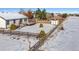 Wide backyard with a rustic wooden fence, patio, shed, and snowy ground at 1180 Crenshaw St, Castle Rock, CO 80104