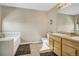 Bathroom featuring double sinks, a soaking tub, tile floor and neutral wall color at 1180 Crenshaw St, Castle Rock, CO 80104