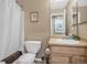 Cozy bathroom features a shower-tub combination, toilet, vanity with sink and neutral decor at 1180 Crenshaw St, Castle Rock, CO 80104