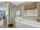 Well-lit bathroom showcasing a soaking tub and glass shower with neutral tones at 1180 Crenshaw St, Castle Rock, CO 80104