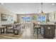 Stylish dining area with a rustic wooden table, a trendy island, and large windows for natural light at 1180 Crenshaw St, Castle Rock, CO 80104