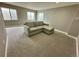 Bright living room features neutral carpet, comfortable sofa, and multiple windows for natural light at 1180 Crenshaw St, Castle Rock, CO 80104