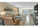 A sunlit living room is furnished with a comfortable gray sofa, leather chair and modern decor at 1180 Crenshaw St, Castle Rock, CO 80104
