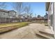 Backyard with a concrete patio, grass, stone borders, and wood fence at 9837 Foxhill Cir, Highlands Ranch, CO 80129