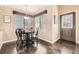 Dining room with dark wood floors, a table with four chairs and natural light from the windows at 9837 Foxhill Cir, Highlands Ranch, CO 80129