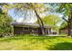 Brick home featuring an expansive yard and a covered patio perfect for outdoor living and entertaining at 1757 S Van Dyke Way, Lakewood, CO 80228