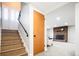 Basement entryway featuring staircase to finished living space with fireplace at 1757 S Van Dyke Way, Lakewood, CO 80228