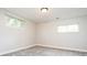 Neutral bedroom with carpet, base trim, and two bright windows at 1757 S Van Dyke Way, Lakewood, CO 80228