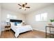 Cozy bedroom with hardwood floors, ceiling fan, and ample natural light at 1757 S Van Dyke Way, Lakewood, CO 80228
