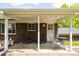 Cozy covered patio with brick exterior and seating area at 1757 S Van Dyke Way, Lakewood, CO 80228