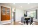 Open concept dining room, with a modern dining set, and a vintage china cabinet at 1757 S Van Dyke Way, Lakewood, CO 80228