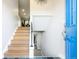 Inviting entryway with wood staircase and a glimpse into the home's layout at 1757 S Van Dyke Way, Lakewood, CO 80228