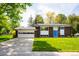 A well maintained brick house featuring an attached garage, and a vibrant green lawn at 1757 S Van Dyke Way, Lakewood, CO 80228