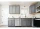 Modern kitchen features gray cabinets, stainless steel appliances, and sleek countertops at 1757 S Van Dyke Way, Lakewood, CO 80228