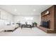 Inviting living room with brick fireplace, plush carpet, and recessed lighting at 1757 S Van Dyke Way, Lakewood, CO 80228