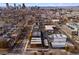 A wide aerial perspective showcases rows of contemporary townhomes nestled amidst a vibrant cityscape and distant mountains at 3285 Lawrence St, Denver, CO 80205