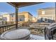 The backyard features a covered patio with a hot tub, perfect for relaxing and enjoying the outdoors with privacy fencing at 222 Fox St, Bennett, CO 80102
