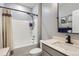 The bathroom showcases a vanity and a shower-tub combo with a shower curtain, creating a functional and pleasant space at 222 Fox St, Bennett, CO 80102