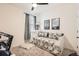 This is a well-lit bedroom that features a daybed, a ceiling fan, neutral walls, and a carpeted floor creating a cozy and inviting space at 222 Fox St, Bennett, CO 80102