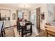 Dining room features hardwood floors, decorative curtains, and a sliding glass door at 222 Fox St, Bennett, CO 80102