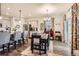Open-concept kitchen and dining room with hardwood floors and bright, floral curtains at 222 Fox St, Bennett, CO 80102