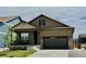 Charming one-story home featuring a covered porch, attached garage and nicely manicured front lawn at 222 Fox St, Bennett, CO 80102