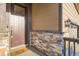 Inviting entryway with stone accents and stylish details, enhancing the curb appeal of the home at 222 Fox St, Bennett, CO 80102